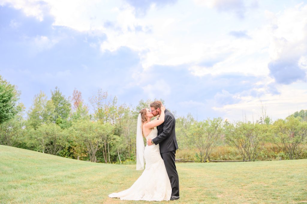 Aiden Laurette Photography | bride and groom kiss in field in hanover ontario