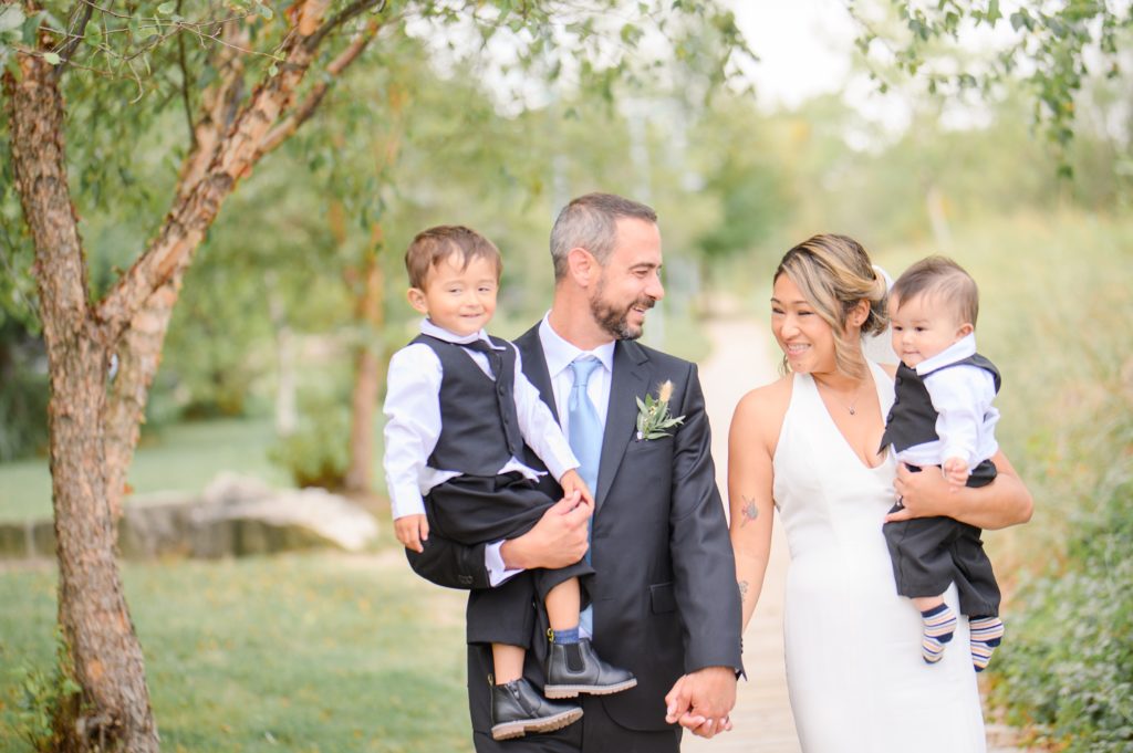 Aiden Laurette Photography | bride and groom pose with children