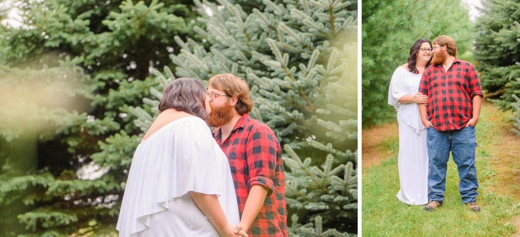 Aiden Laurette Photography | Woman in white dress and man in plaid shirt kiss near evergreen trees