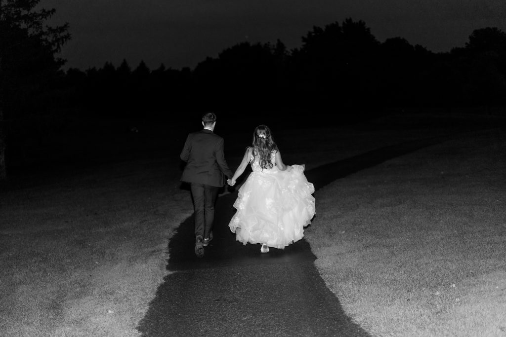 Aiden Laurette Photography | bride and groom walk down moonlit path