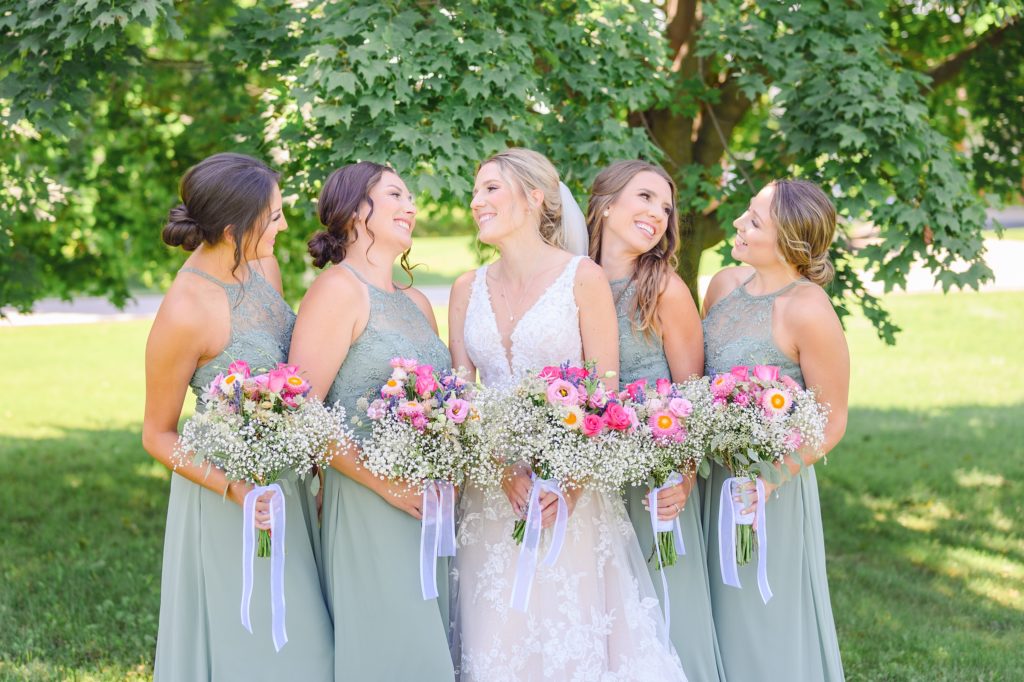 Aiden Laurette Photography | bride poses with bridesmaids under tree