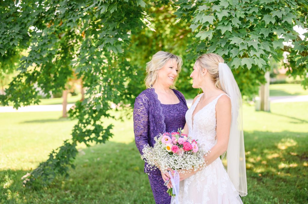 Aiden Laurette Photography | bride poses with woman in purple dress