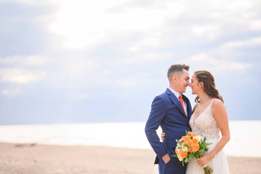 Aiden Laurette Photography | bride and groom pose on beach in grand bend ontario