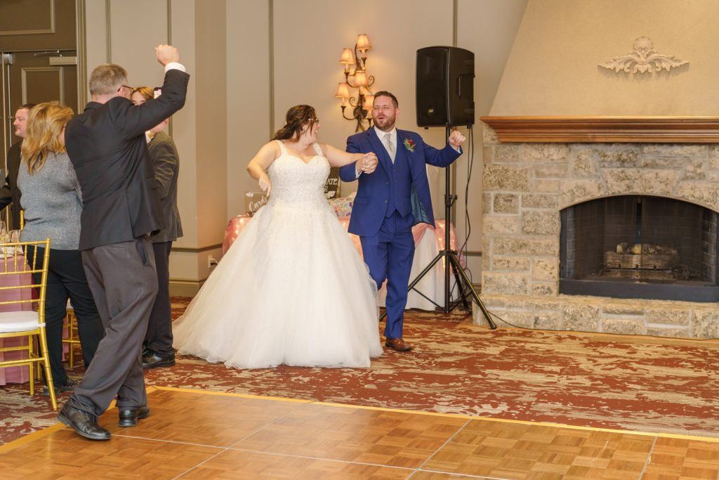Aiden Laurette Photography | bride and groom enter reception at rose chapel london ontario