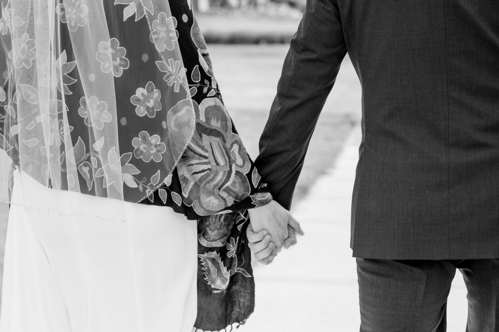 Aiden Laurette Photography | bride and groom hold hands 