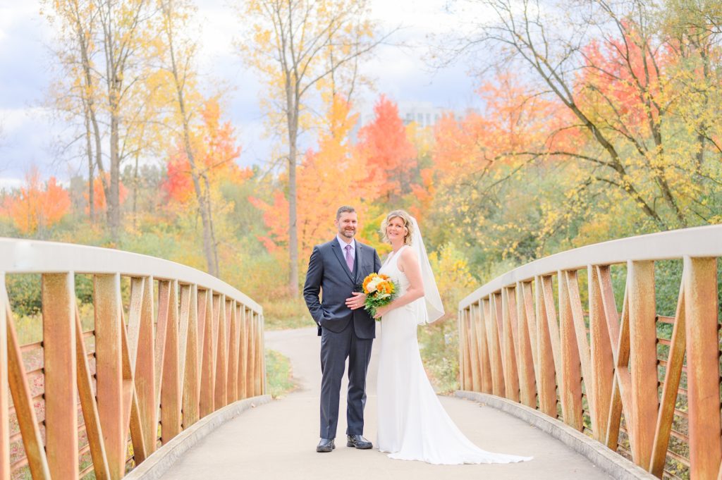 Aiden laurette photography | bride and groom pose in fall wedding