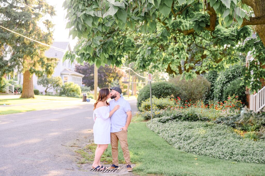 Aiden Laurette Photography | An engaged couple kisses in a park