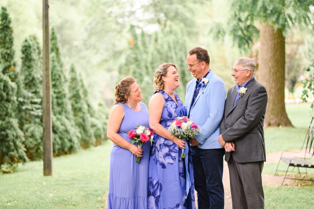 Aiden Laurette Photography | Wedding party poses in front of greenery