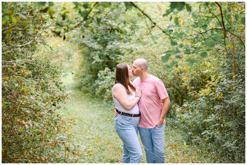 Aiden Laurette Photography | Couple kisses surrounded by greenery