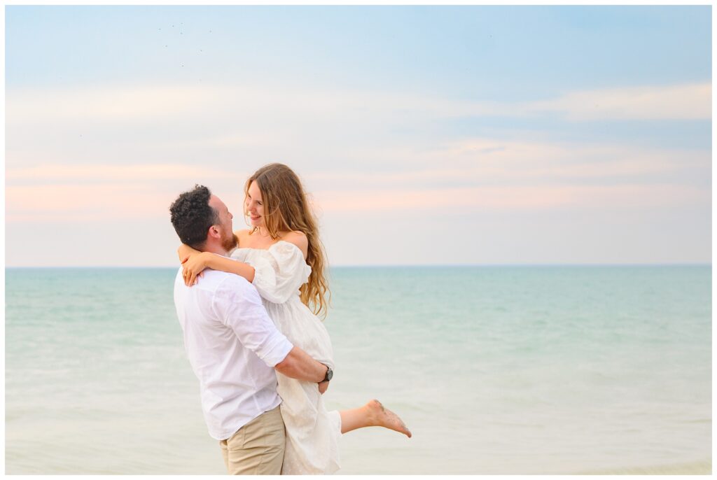 Aiden Laurette Photography | couple poses in front of water