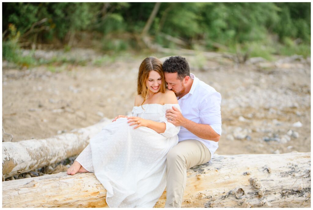 Aiden Laurette Photography | couple poses in front of water