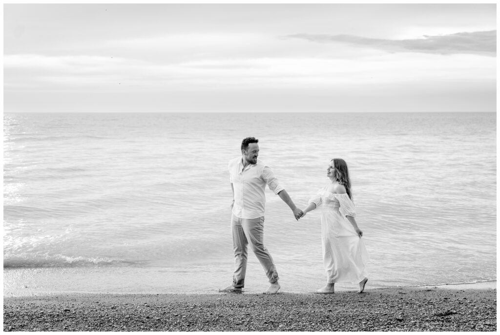 Aiden Laurette Photography | couple poses in front of water