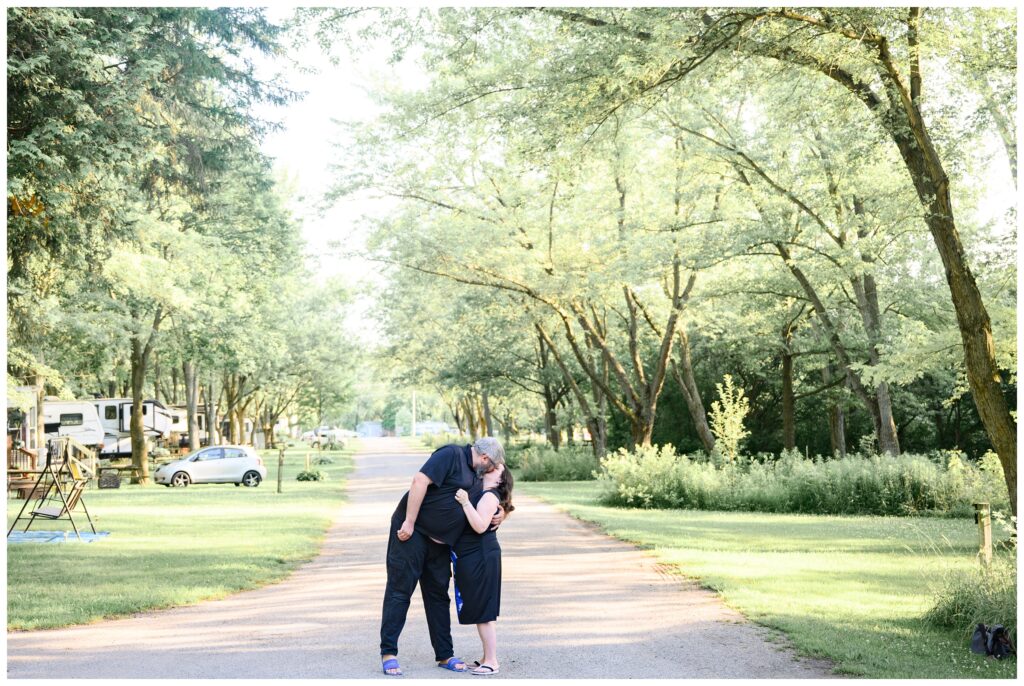 Aiden Laurette Photography | couple poses in front of greenery