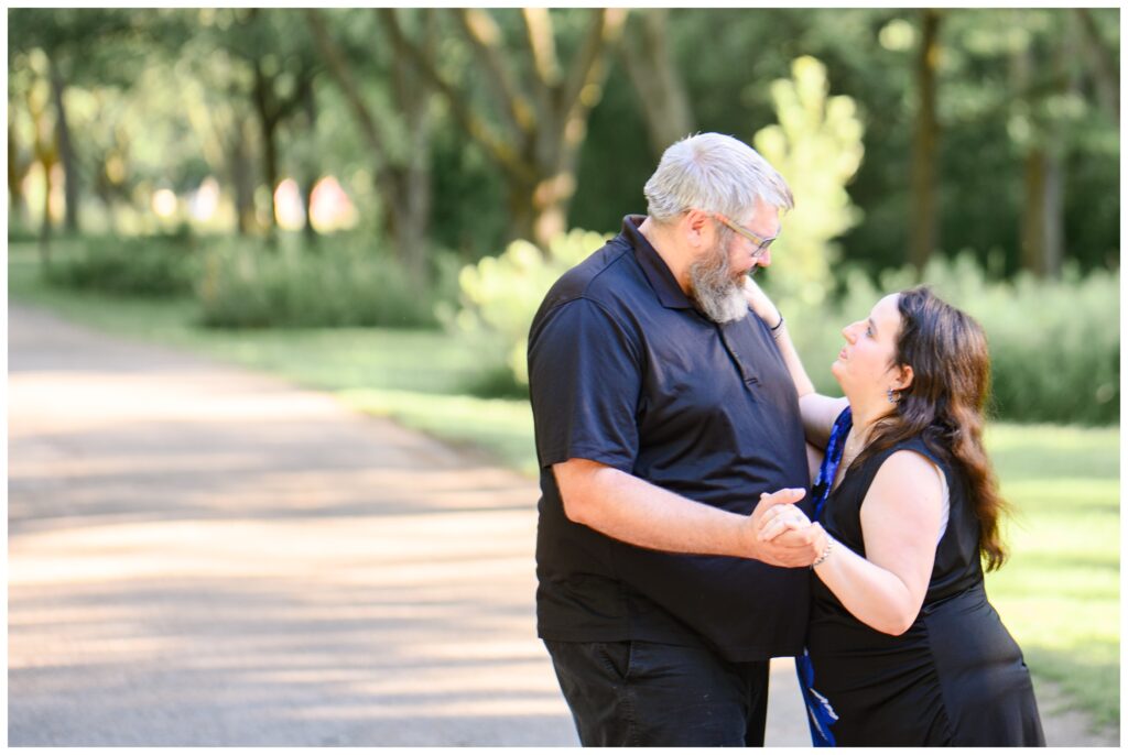 Aiden Laurette Photography | couple poses in front of greenery