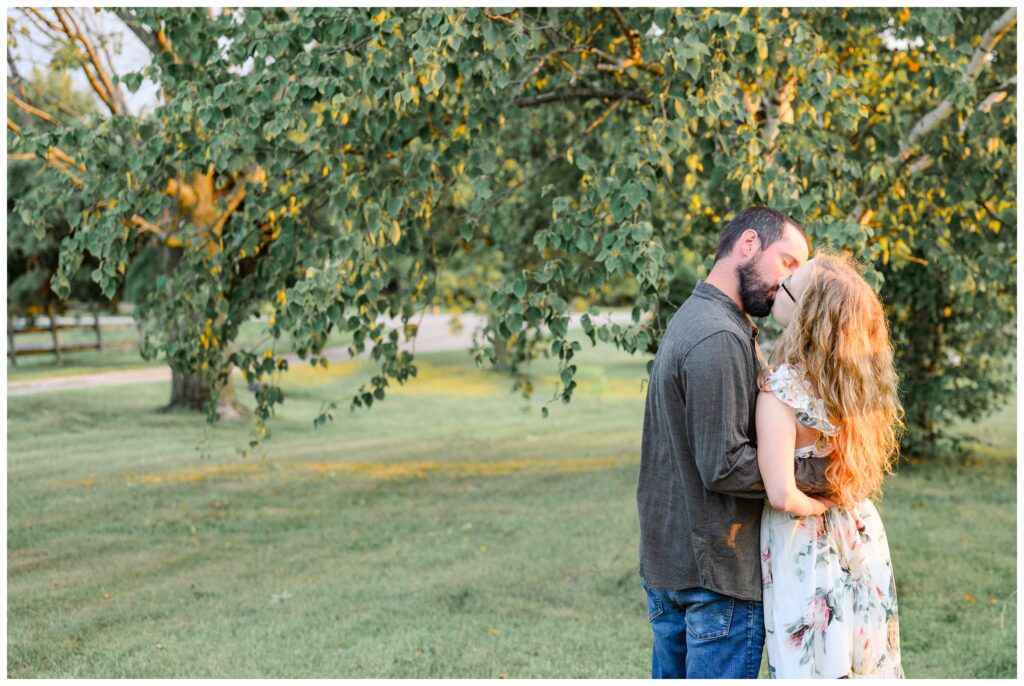 Aiden Laurette Photography | couple kisses in pasture